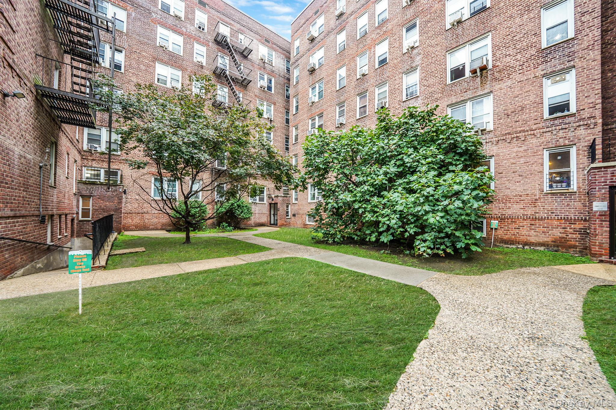 35-40 75th Street, Unit 1B Queens, NY 11372 - Photo 2 of 19 View of home's community with a yard