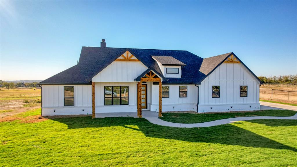 a front view of house with yard and garage