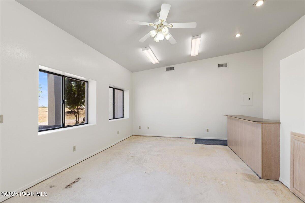 1445 South Table Mountain Road Chino Valley, AZ 86323 - Photo 21 of 81 an empty room with chandelier fan and windows