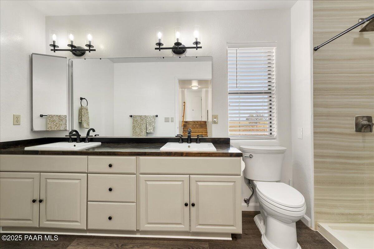 1445 South Table Mountain Road Chino Valley, AZ 86323 - Photo 31 of 81 a bathroom with a sink and mirror with toilet