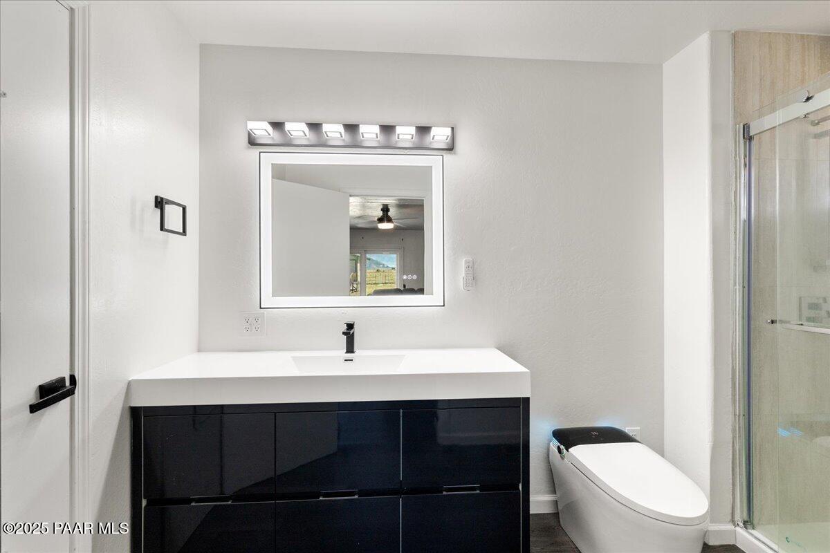 1445 South Table Mountain Road Chino Valley, AZ 86323 - Photo 34 of 81 a bathroom with a sink toilet and mirror