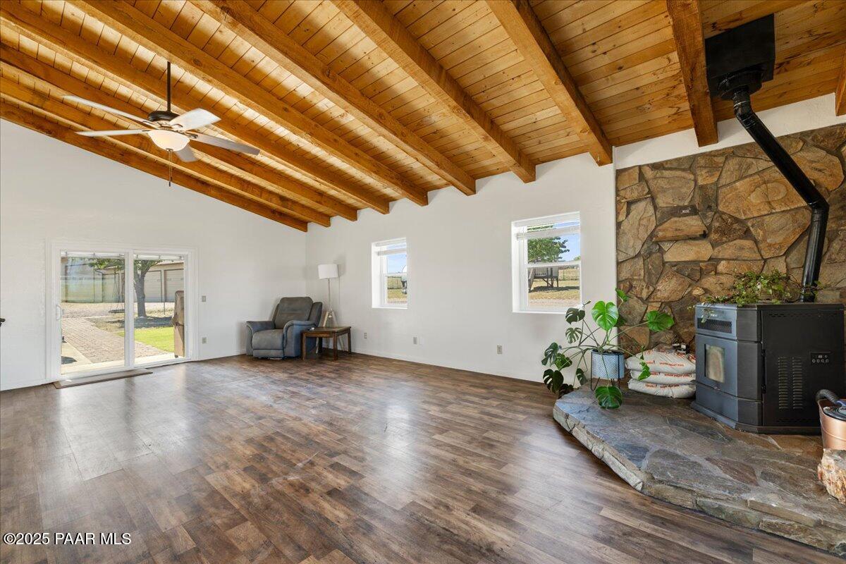 1445 South Table Mountain Road Chino Valley, AZ 86323 - Photo 8 of 81 a view of an empty room with wooden floor and a window
