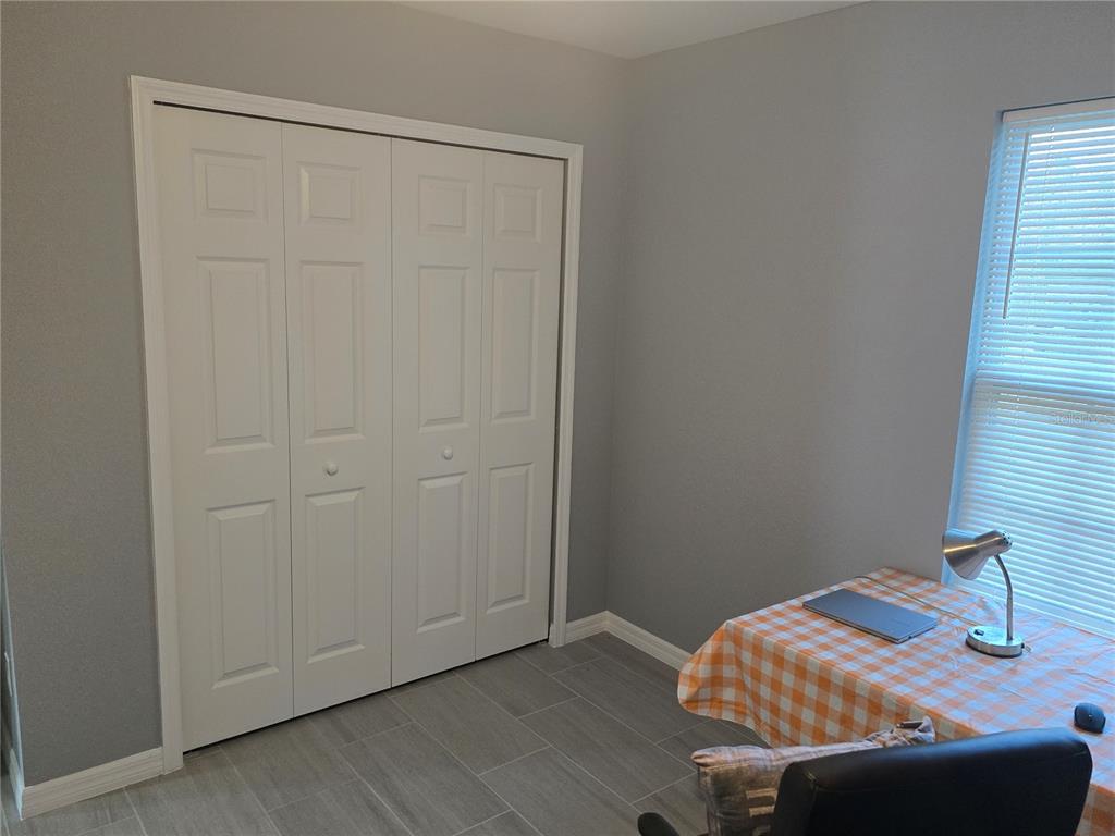 838 Northwest 124th Street Citra, FL 32113 - Photo 15 of 27 a bedroom with a bed and a window