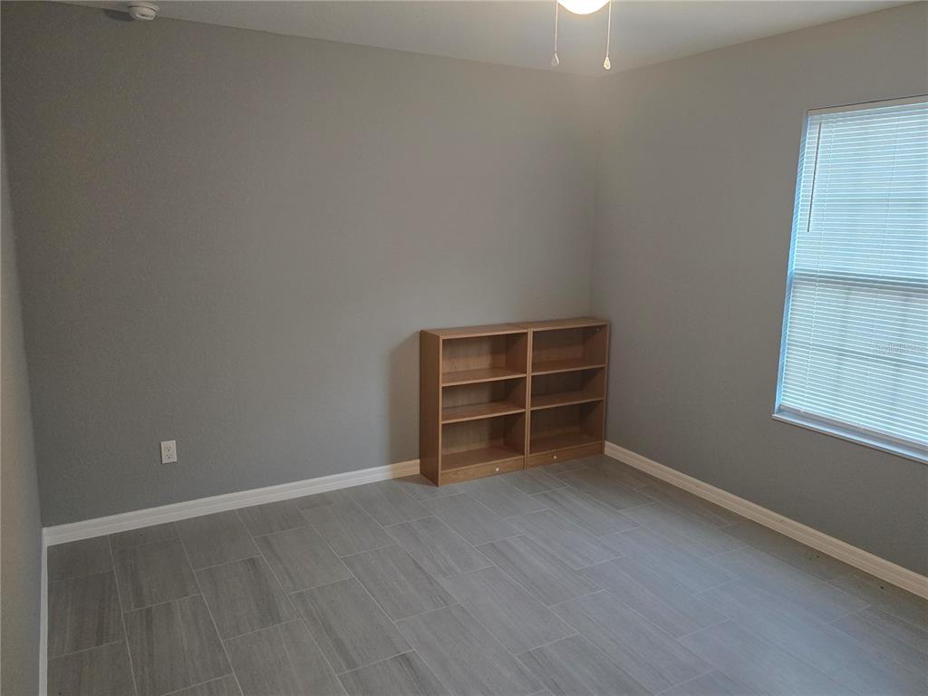 838 Northwest 124th Street Citra, FL 32113 - Photo 18 of 27 an empty room with wooden floor and empty shelves