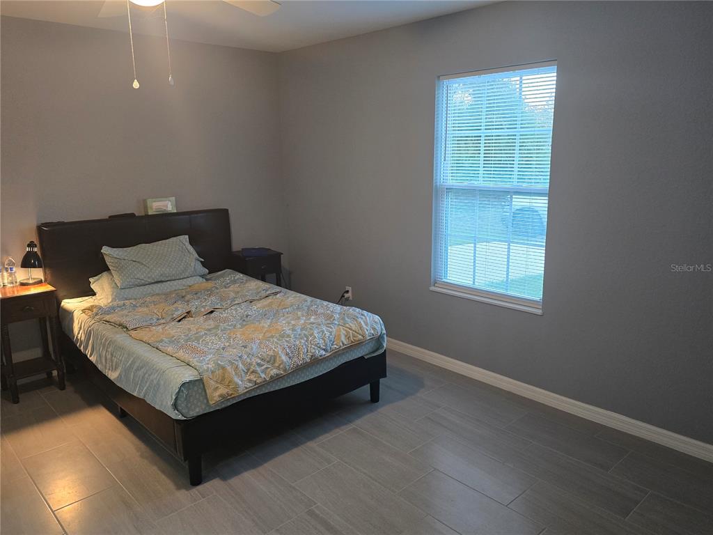 838 Northwest 124th Street Citra, FL 32113 - Photo 20 of 27 a bedroom with a bed and window