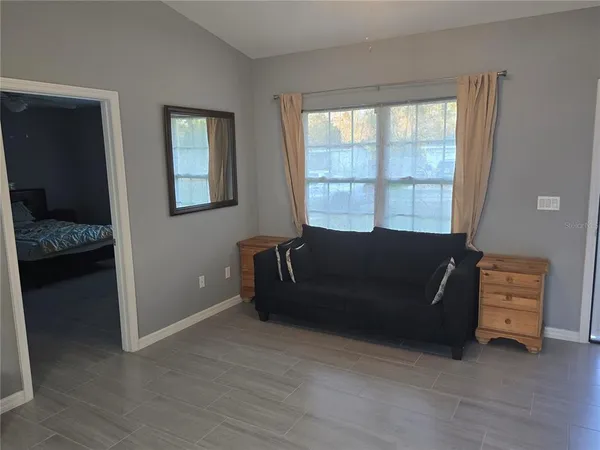 a living room with furniture and a window