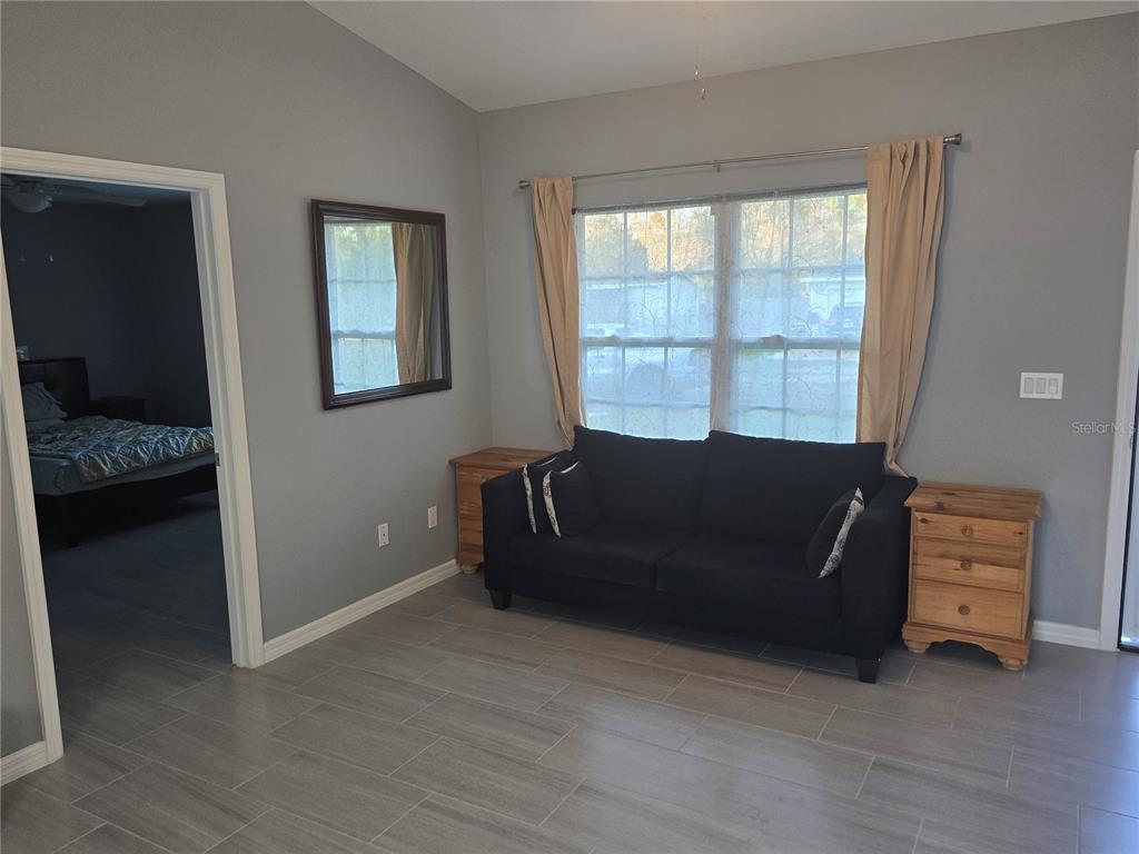 838 Northwest 124th Street Citra, FL 32113 - Photo 7 of 27 a living room with furniture and a window
