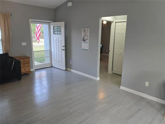 a view of an entryway with wooden floor