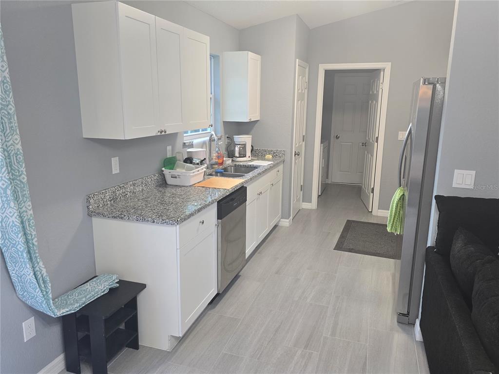 838 Northwest 124th Street Citra, FL 32113 - Photo 10 of 27 a kitchen with a sink stove and refrigerator