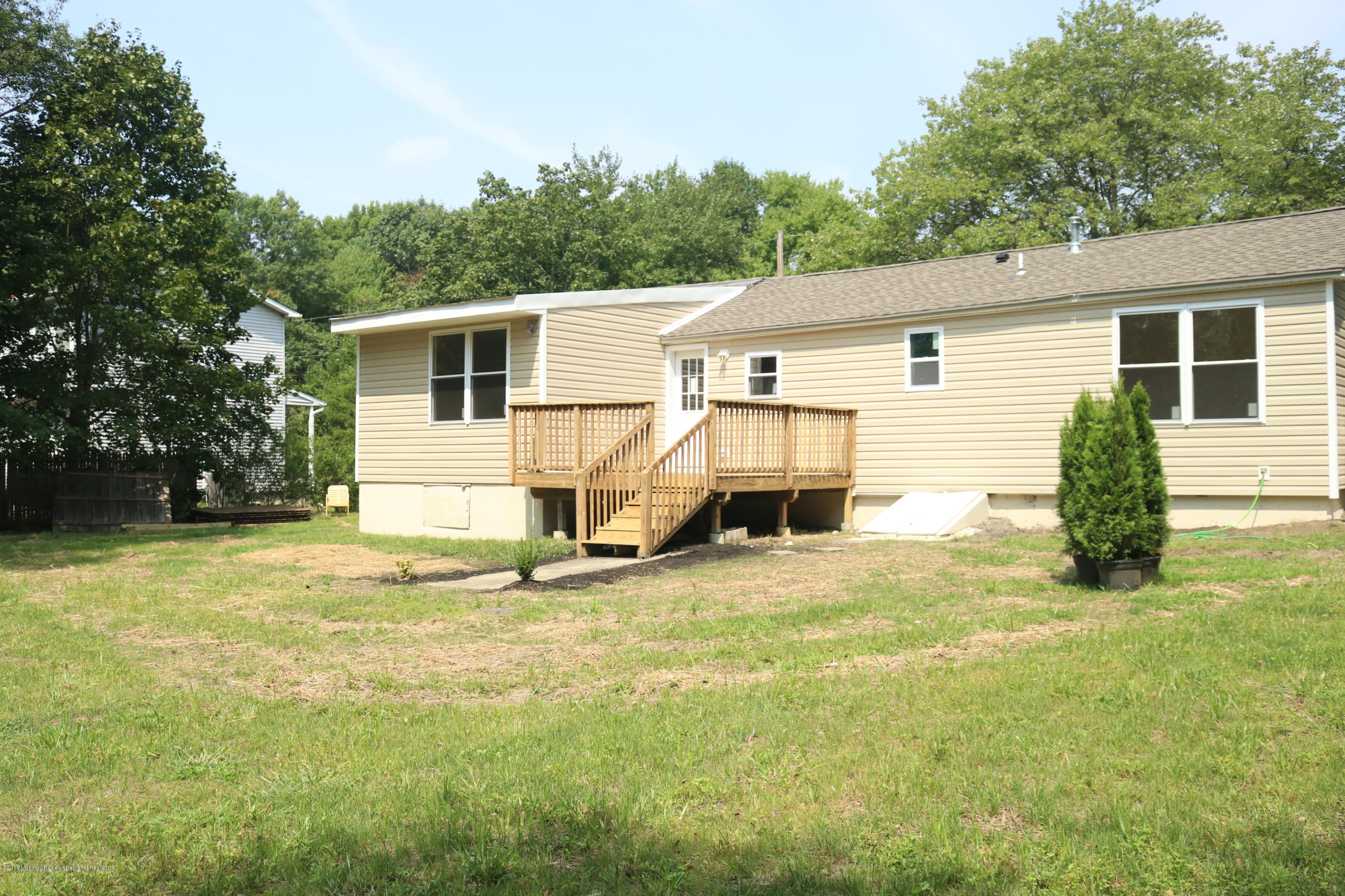 257 Spring Valley Road Morganville, NJ 07751 - Photo 6 of 32 a view of a house with a yard and garage