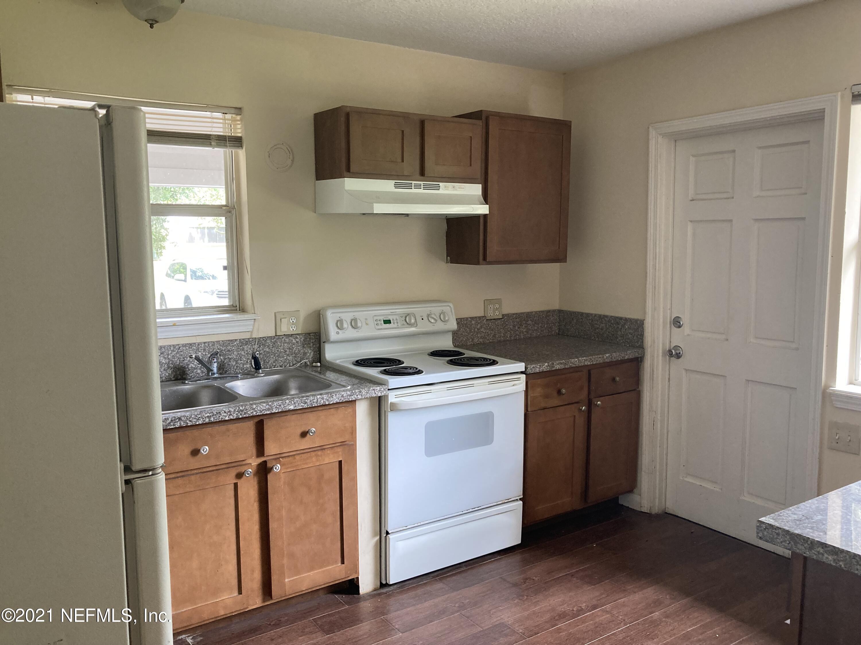 6422 Swallow Cove Road Jacksonville, FL 32211 - Photo 13 of 17 a kitchen with a stove and wooden cabinets