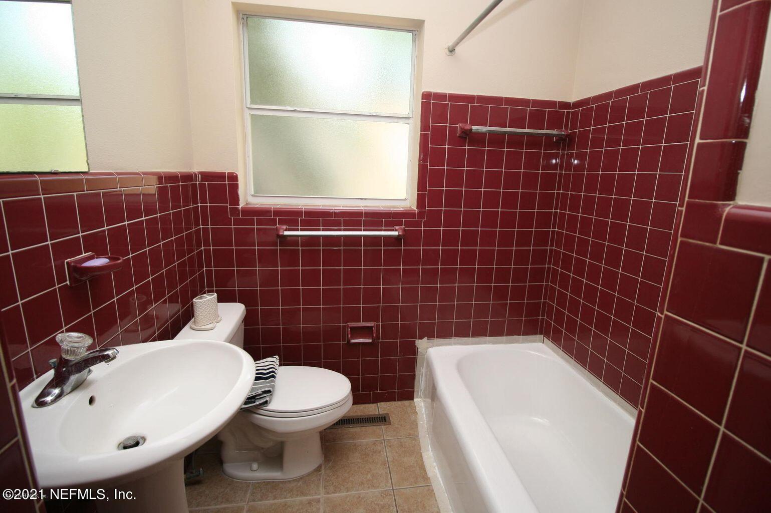6422 Swallow Cove Road Jacksonville, FL 32211 - Photo 16 of 17 a bathroom with a toilet a sink and mirror