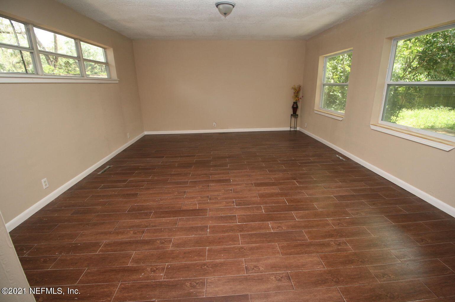 6422 Swallow Cove Road Jacksonville, FL 32211 - Photo 4 of 17 wooden floor in an empty room with a window
