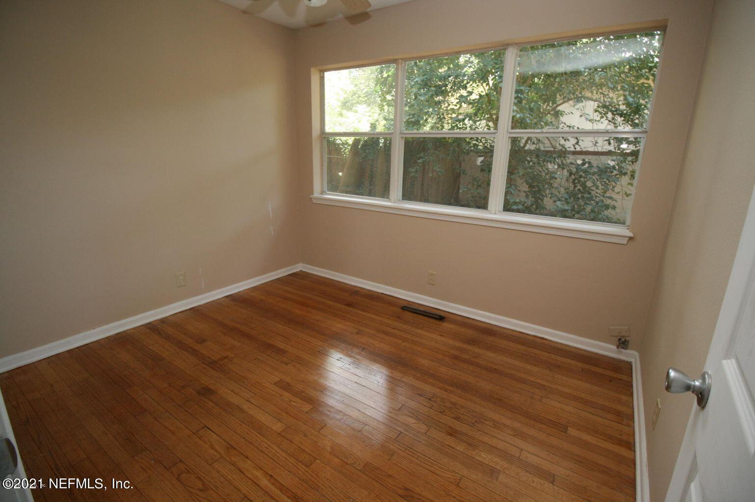 6422 Swallow Cove Road Jacksonville, FL 32211 - Photo 6 of 17 a view of empty room with wooden floor and fan