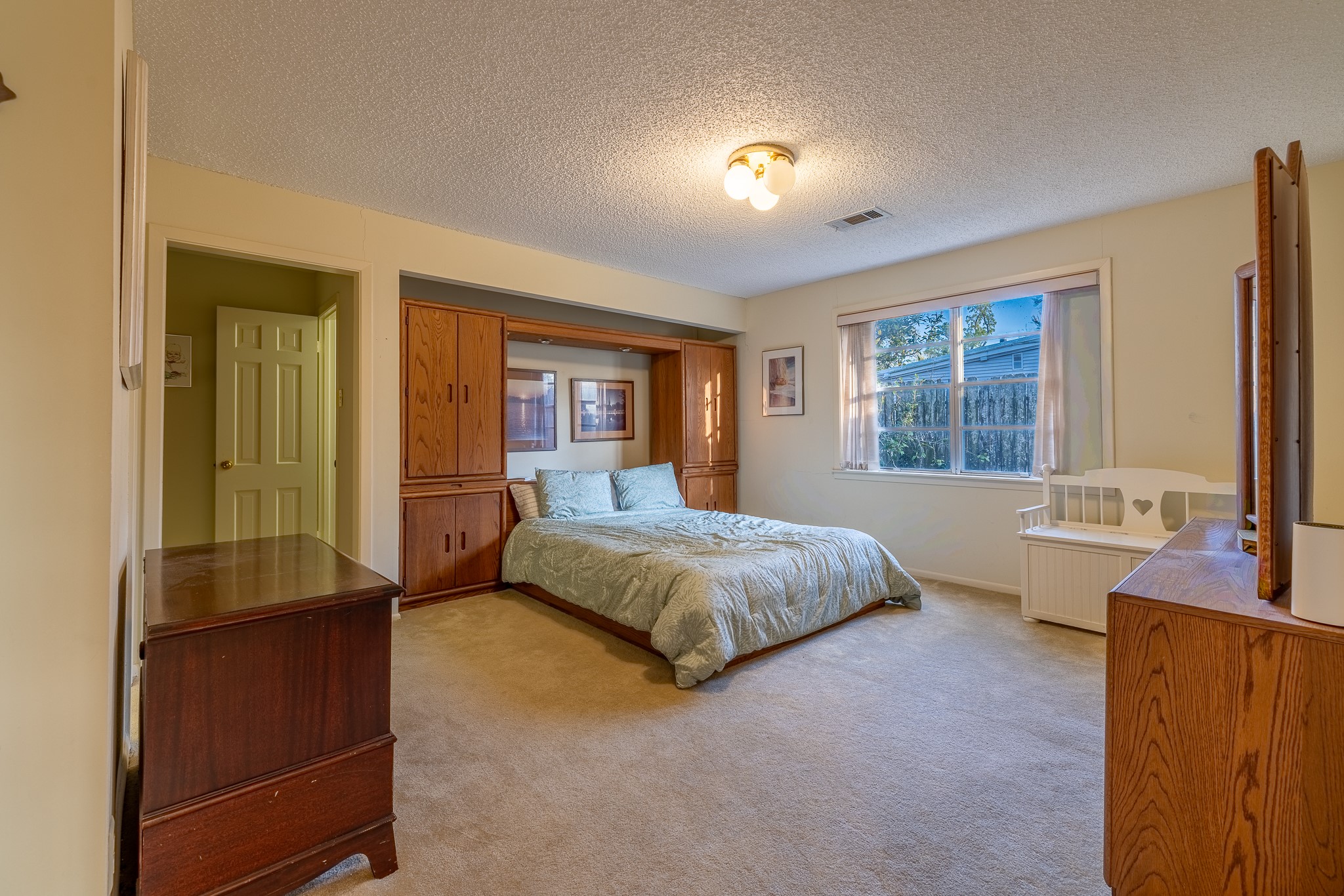 506 Timber Terrace Road Houston, TX 77024 - Photo 12 of 12 a spacious bedroom with a large bed and a chandelier