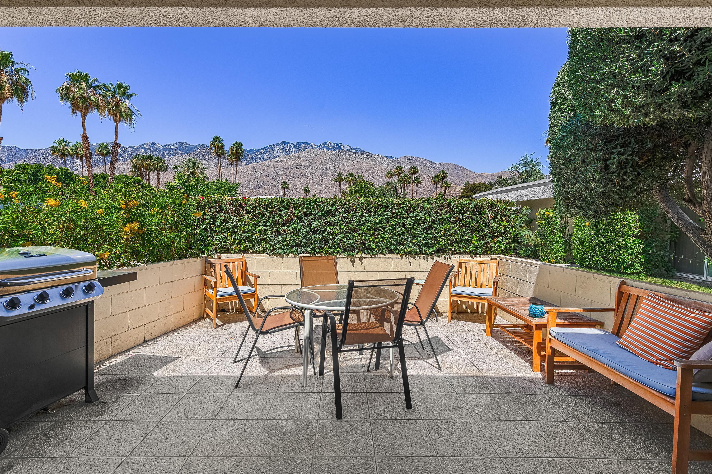 1855 Ramon Road, Unit 14 Palm Springs, CA 92264 - Photo 1 of 34 a view of a tables and chairs on the roof deck