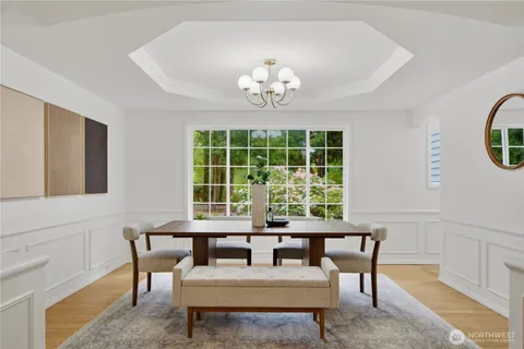 a view of a dining room with furniture a rug and a large window