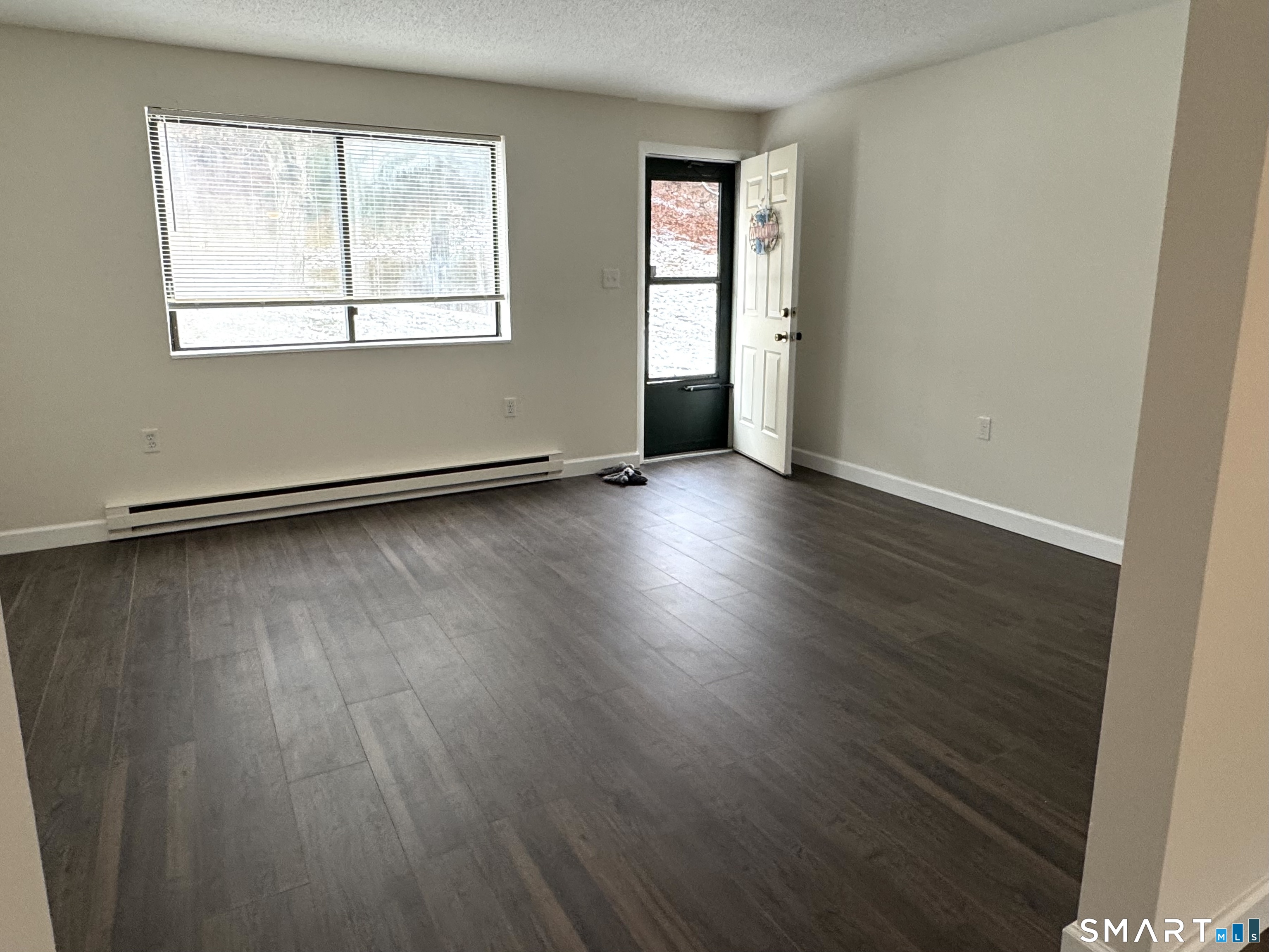 39 Horton Hill Road, Unit 6E Naugatuck, CT 06770 - Photo 17 of 26 an empty room with wooden floor and windows