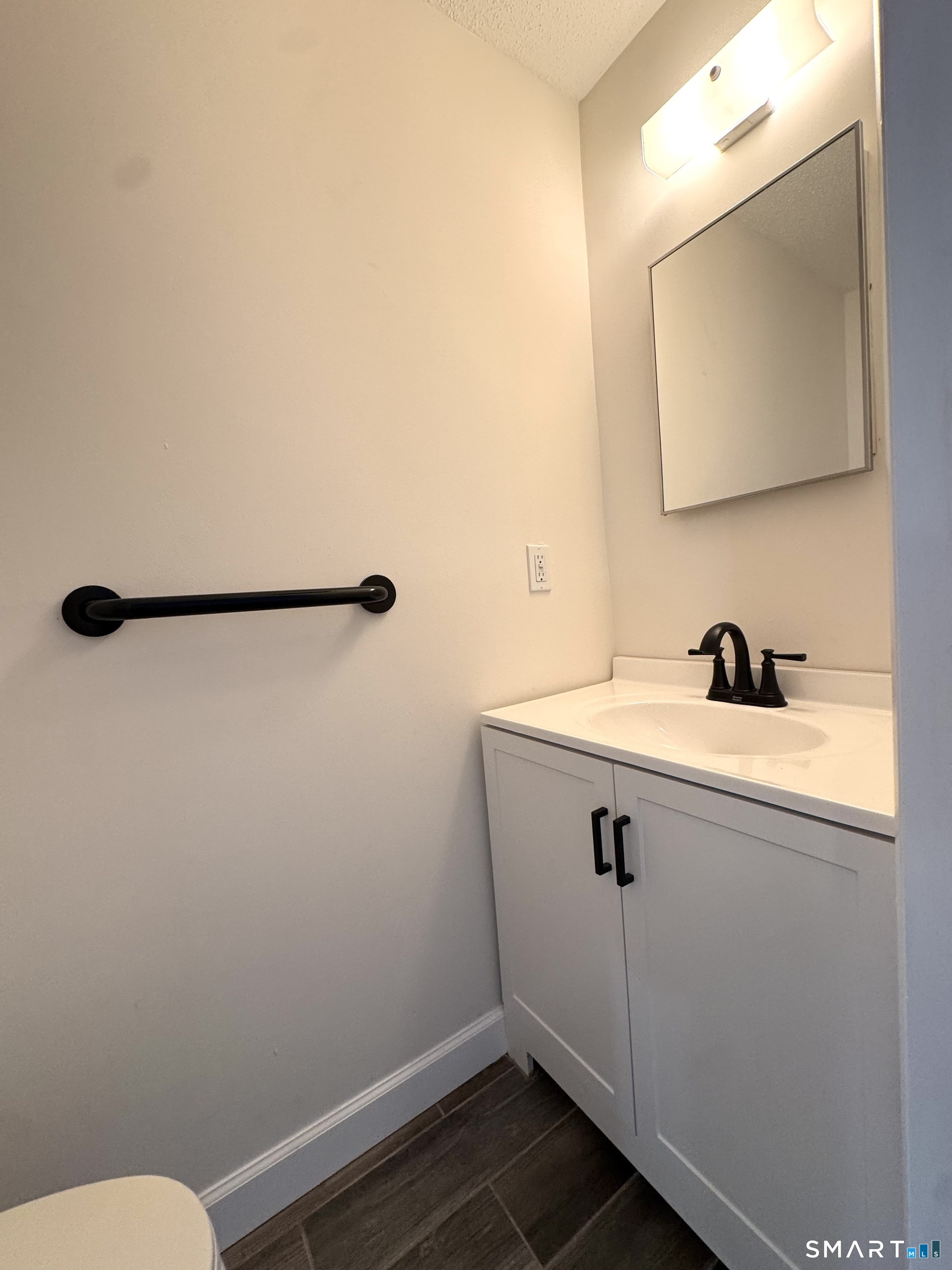 39 Horton Hill Road, Unit 6E Naugatuck, CT 06770 - Photo 18 of 26 a bathroom with a sink a toilet and mirror