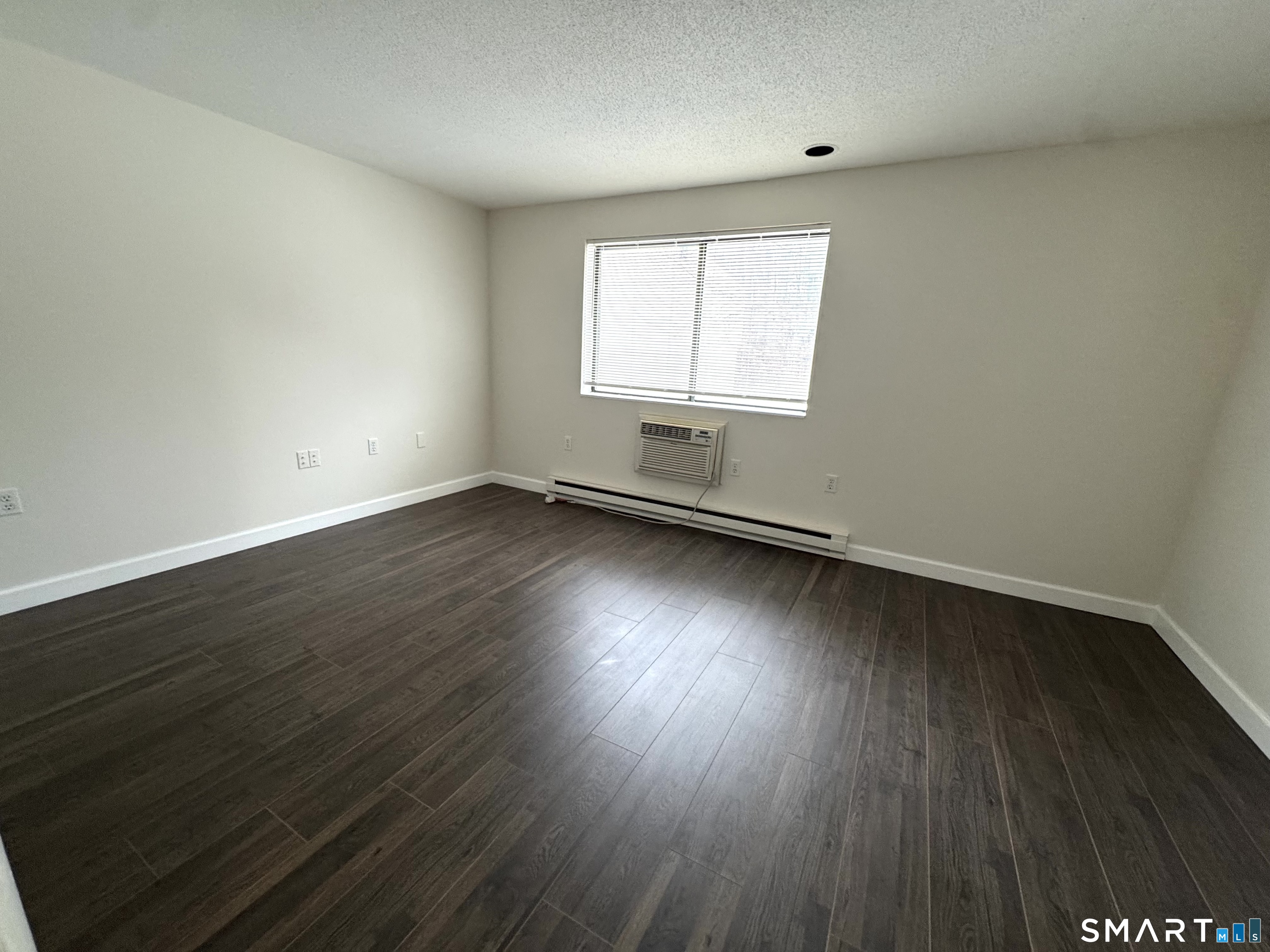 39 Horton Hill Road, Unit 6E Naugatuck, CT 06770 - Photo 3 of 26 an empty room with wooden floor and windows