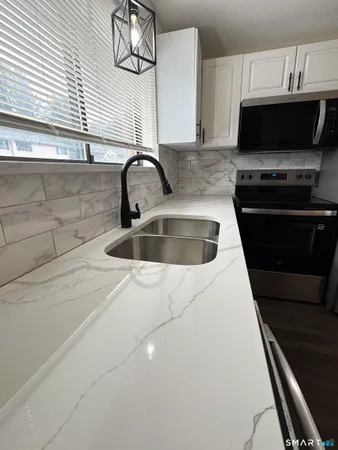 a kitchen with a sink and a stove