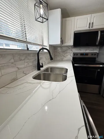 a kitchen with a sink and a stove