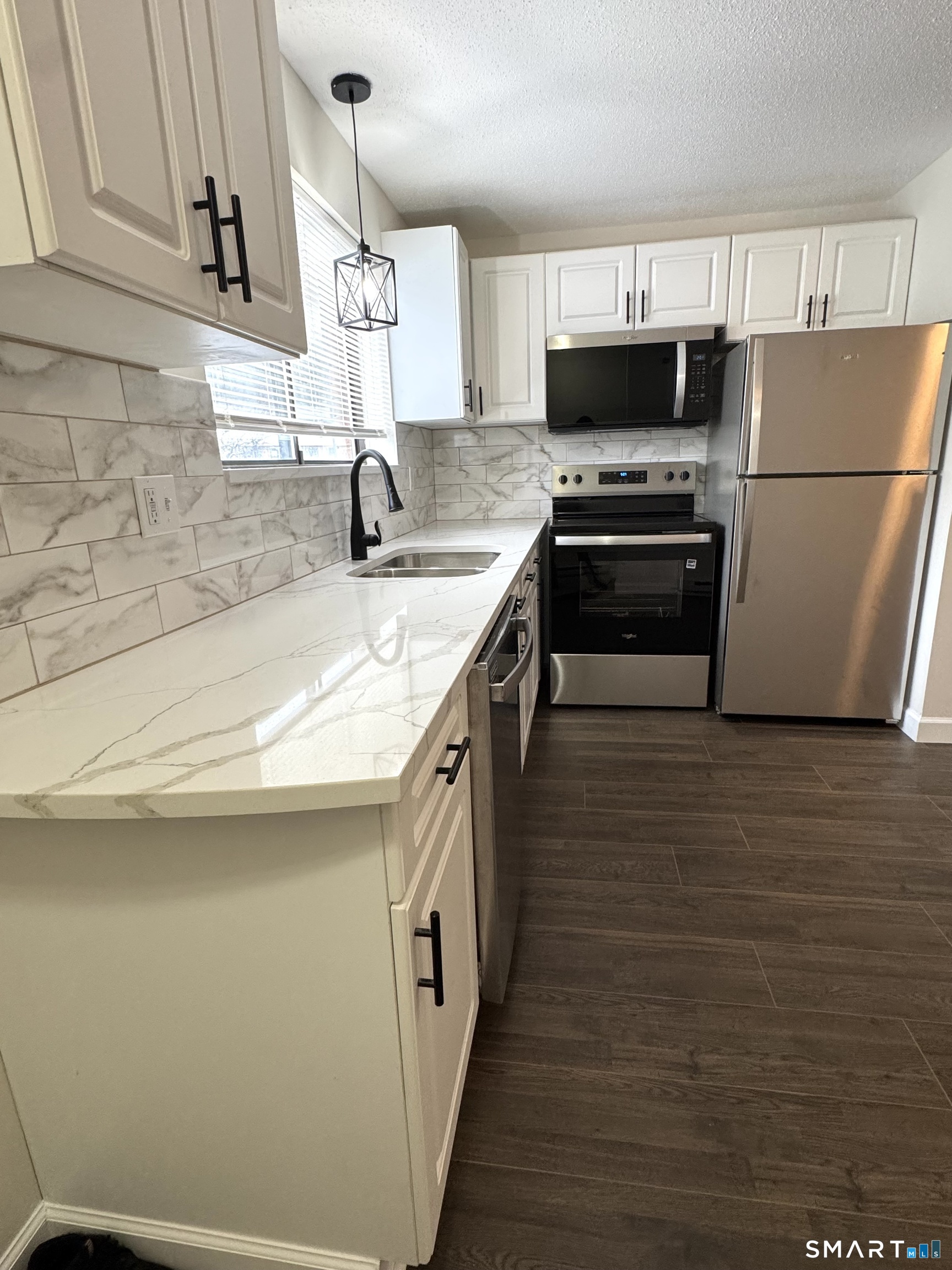 39 Horton Hill Road, Unit 6E Naugatuck, CT 06770 - Photo 8 of 26 a kitchen with stainless steel appliances a sink dishwasher a refrigerator a stove top oven a counter space and cabinets