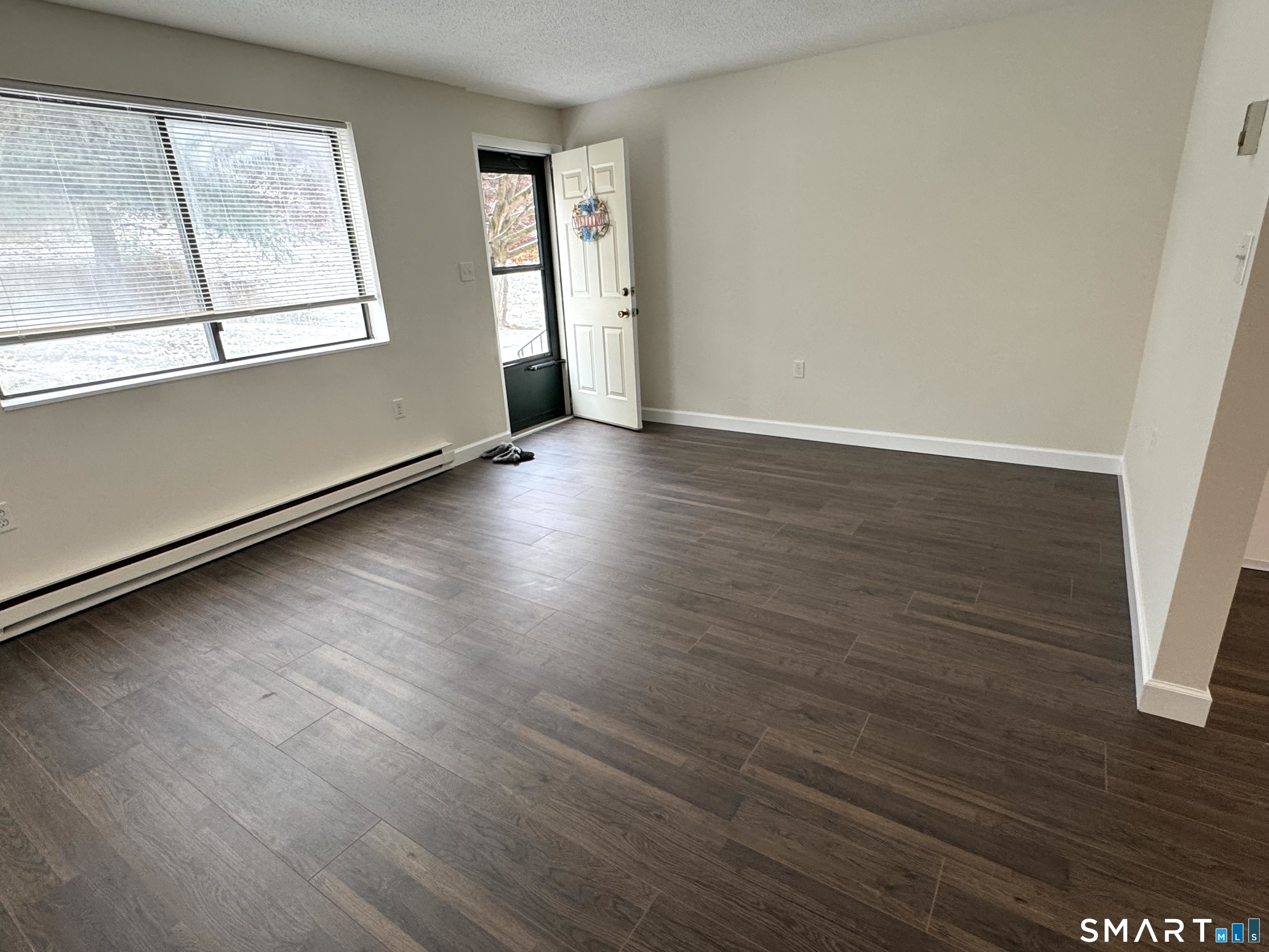 39 Horton Hill Road, Unit 6E Naugatuck, CT 06770 - Photo 10 of 26 an empty room with wooden floor and windows