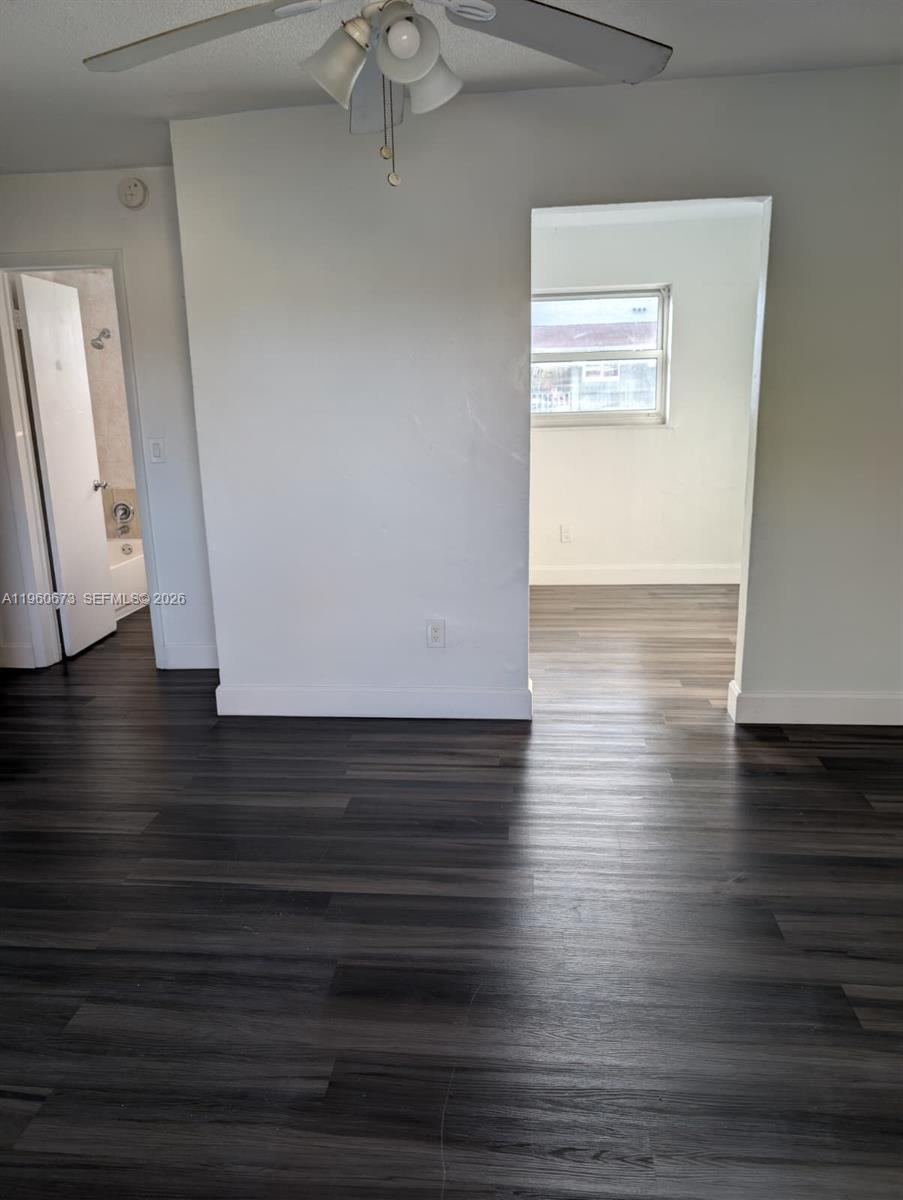 1461 Southwest 5th Street, Unit 2 Miami, FL 33135 - Photo 2 of 16 a view of an empty room with wooden floor and a window