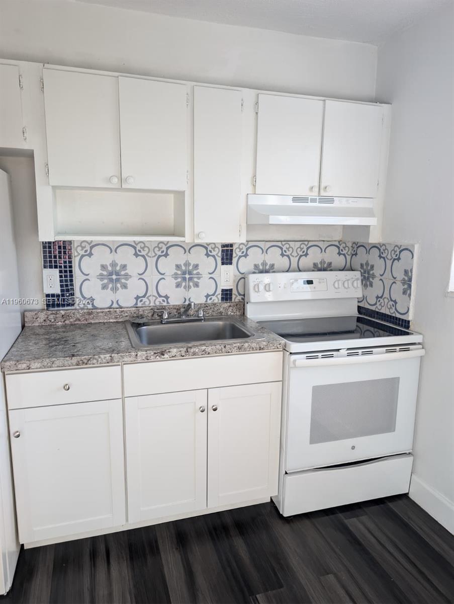 1461 Southwest 5th Street, Unit 2 Miami, FL 33135 - Photo 7 of 16 a stove top oven sitting inside of a kitchen