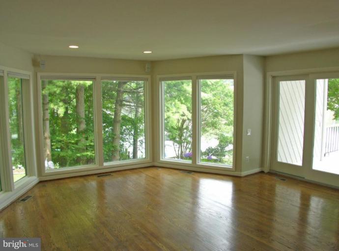 2204 Spinnaker Court Reston, VA 20191 - Photo 12 of 20 a view of an empty room with wooden floor and a window