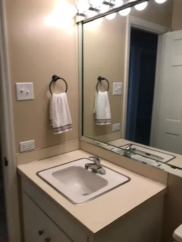 a living room with furniture and a lamp