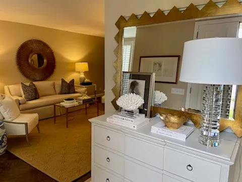 a living room with furniture and a mirror