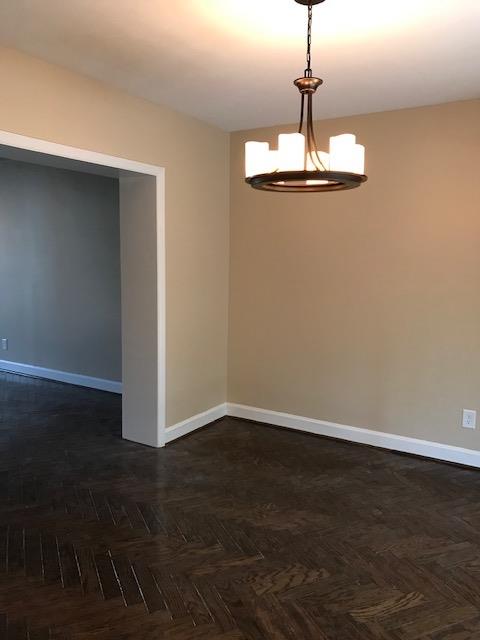 2312 15th Street, Unit B Columbus, GA 31906 - Photo 7 of 30 a view of a room with wooden floor and a ceiling fan