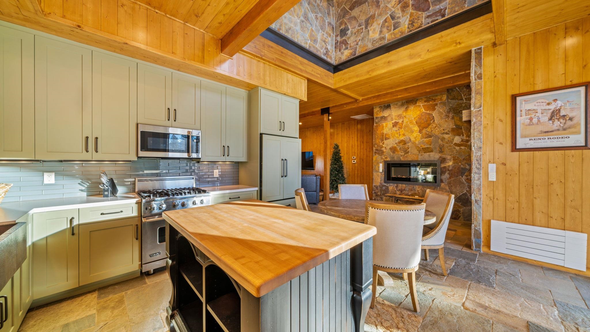 6200 Westside Road Calpine, CA 96124 - Photo 18 of 21 a kitchen with a stove a refrigerator and a dining table with chairs
