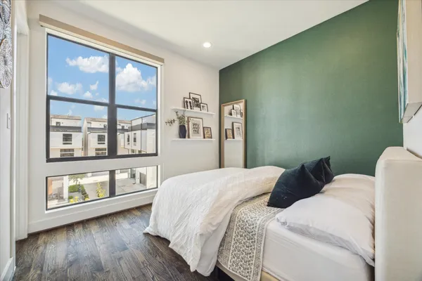 a bedroom with a bed and a large window