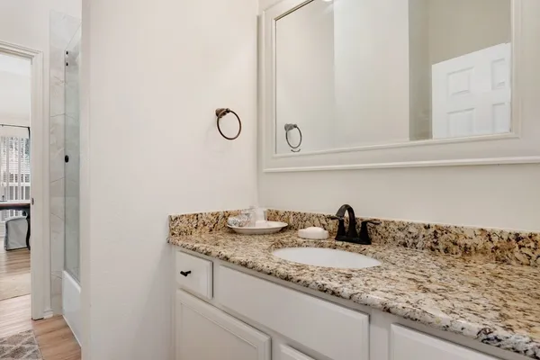 a bathroom with a sink and vanity