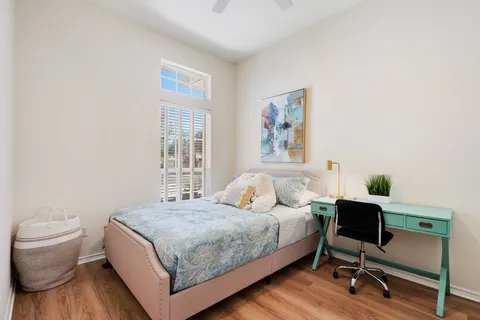 a bedroom with a bed and a desk