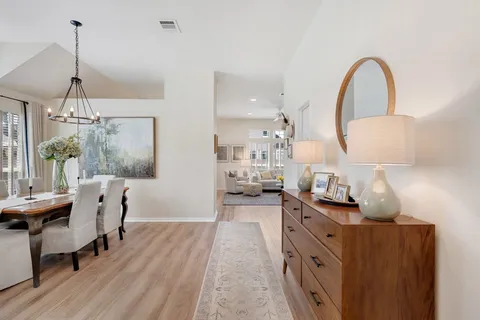 a kitchen with stainless steel appliances a table and chairs