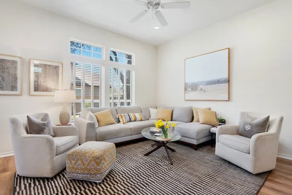 a living room with furniture a rug and a chandelier