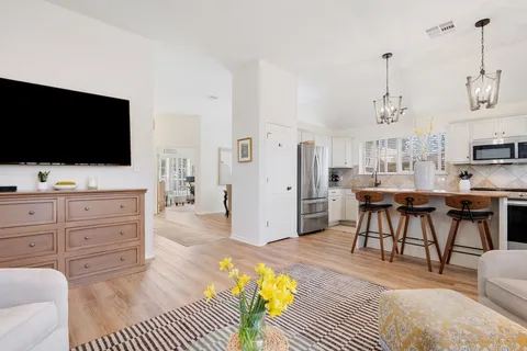 a view of a livingroom with furniture and a flat screen tv