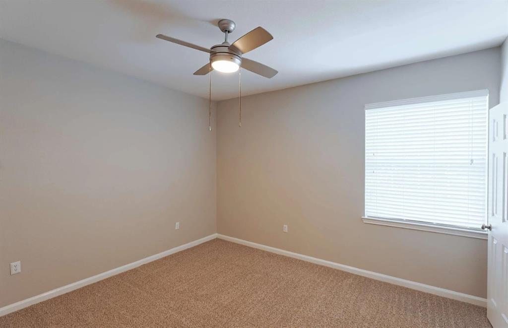 10505 I-35 Frontage Road South, Unit 527 Austin, TX 78747 - Photo 20 of 22 an empty room with a window and a fan
