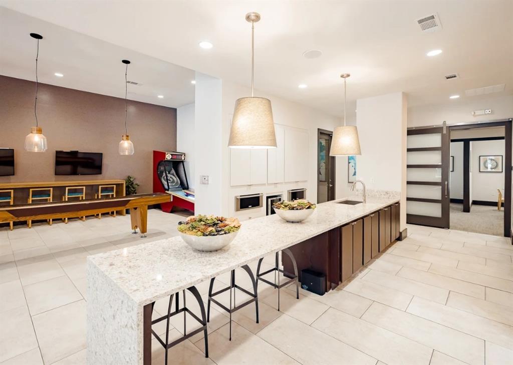 10505 I-35 Frontage Road South, Unit 527 Austin, TX 78747 - Photo 8 of 22 a kitchen with stainless steel appliances kitchen island granite countertop a sink and cabinets