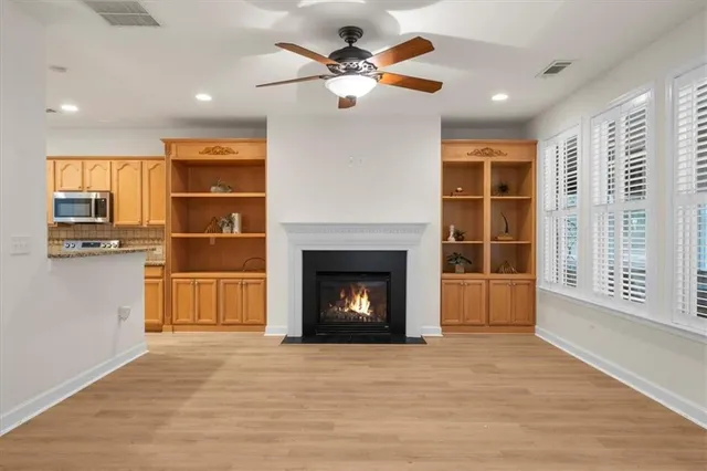a view of a livingroom with a fireplace and window