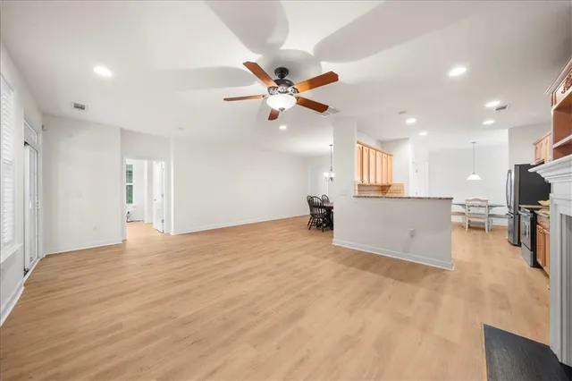 a view of a kitchen with a sink and a refrigerator