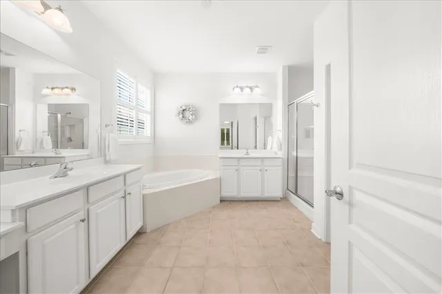 a bathroom with a tub sink and mirror