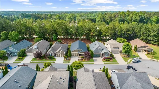 an aerial view of residential houses with outdoor space and swimming pool