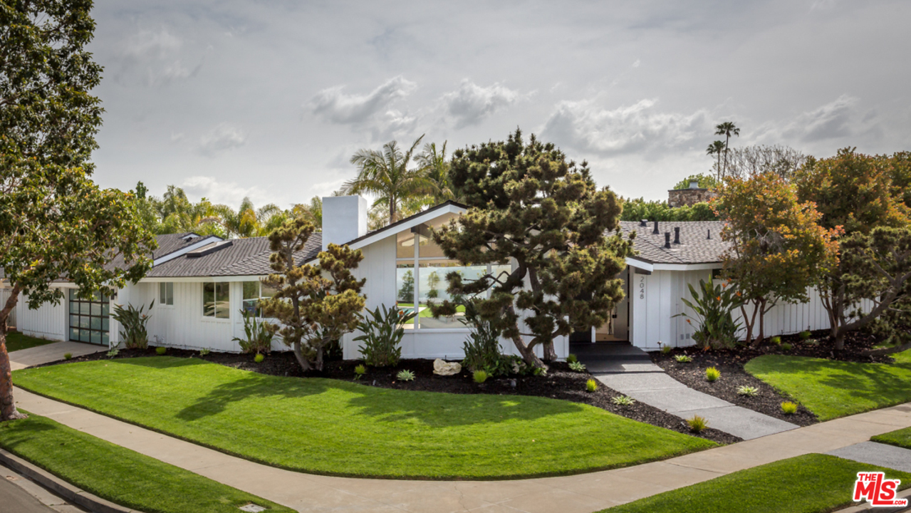 2048 Commodore Road Newport Beach, CA 92660 - Photo 1 of 39 a view of a white house with a yard and potted plants
