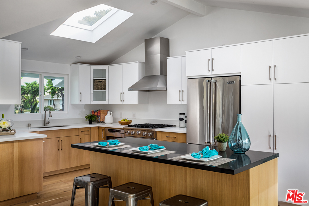 2048 Commodore Road Newport Beach, CA 92660 - Photo 13 of 39 a kitchen with stainless steel appliances a sink a stove and a refrigerator