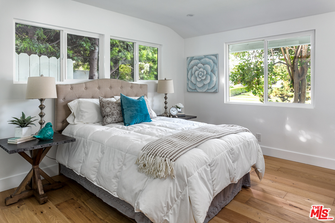 2048 Commodore Road Newport Beach, CA 92660 - Photo 15 of 39 a bedroom with a bed a table and a large window
